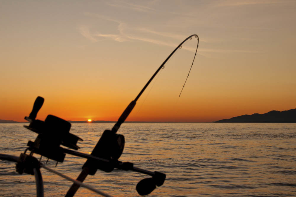 vara de pesca no mar ao pôr do sol em um dos lugares para pescar em SP